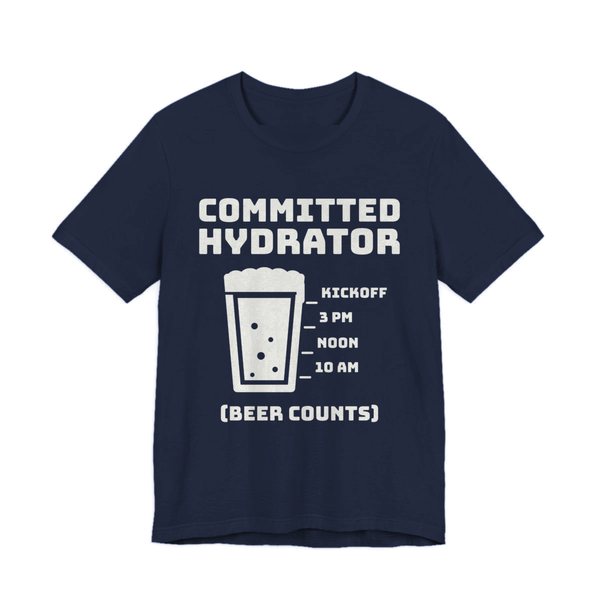Navy t-shirt printed in off-white ink with “Committed Hydrator” above a pint glass with fill lines marked 10 AM, Noon, 3 PM and Kickoff, and “(Beer Counts)”