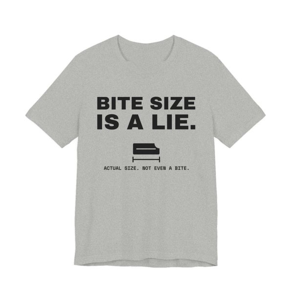 Athletic Heather t-shirt printed in dark ink with “Bite Size Is a Lie.” above a tiny candy bar labeled “Actual size. Not even a bite.”