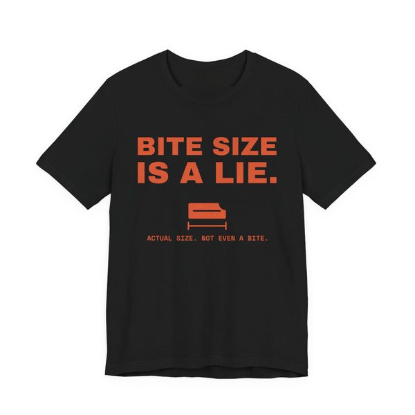 Black t-shirt printed in orange ink with “Bite Size Is a Lie.” above a tiny candy bar labeled “Actual size. Not even a bite.”