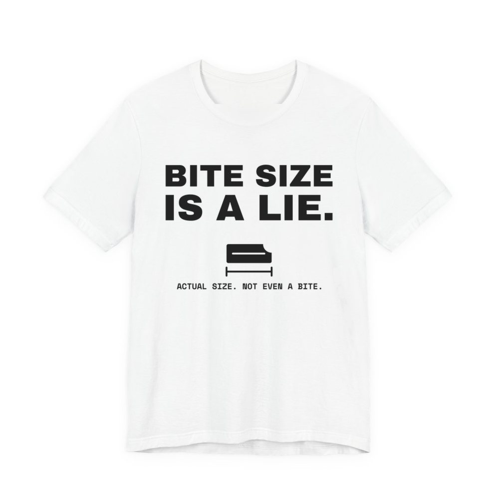 White t-shirt printed in dark ink with “Bite Size Is a Lie.” above a tiny candy bar labeled “Actual size. Not even a bite.”