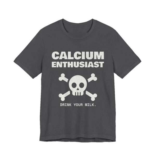 Dark Grey Heather t-shirt printed in off-white ink with “Calcium Enthusiast” above a skull and crossbones, with “Drink your milk.”