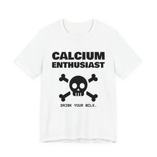 White t-shirt printed in dark ink with “Calcium Enthusiast” above a skull and crossbones, with “Drink your milk.”