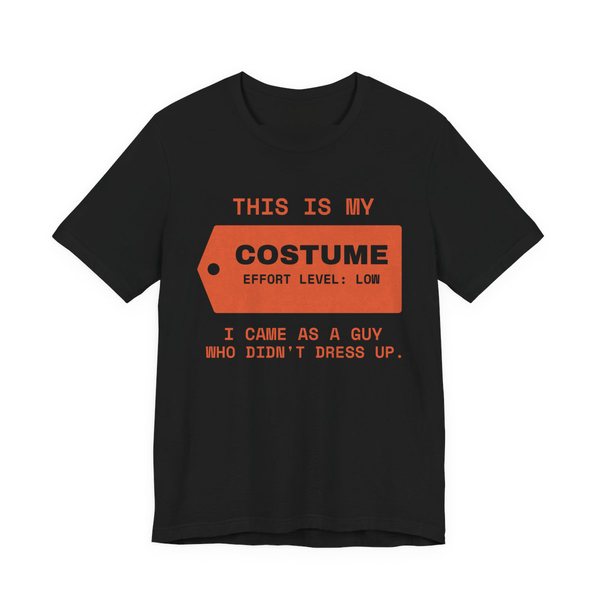 Black t-shirt printed in orange ink with “This Is My” above a hang tag reading “Costume, effort level: low”, with “I came as a guy who didn't dress up.”