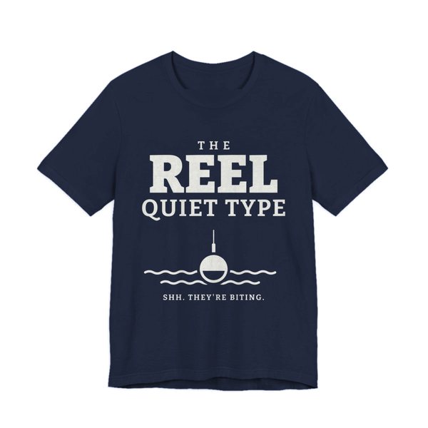 Navy t-shirt printed in off-white ink with “The Reel Quiet Type” above a bobber floating on calm water, with “Shh. They're biting.”