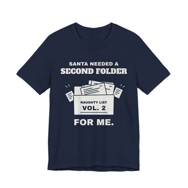 Navy t-shirt printed in off-white ink with “Santa Needed a Second Folder for Me” with an overstuffed file box labeled “Naughty List Vol. 2”