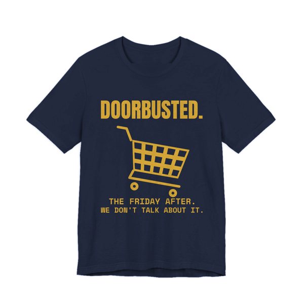 Navy t-shirt printed in gold ink with the word “Doorbusted.”