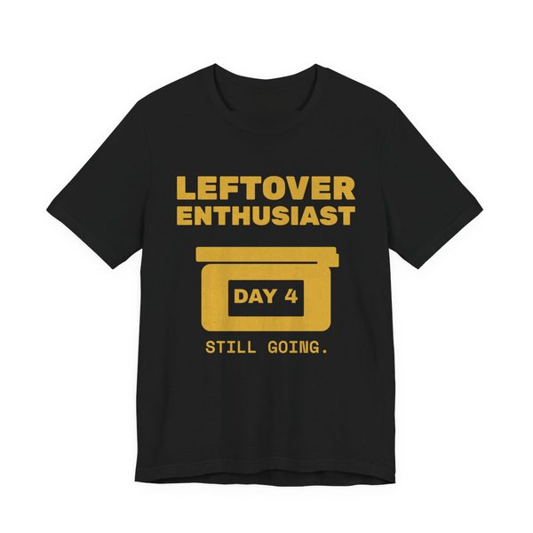 Black t-shirt printed in gold ink with a takeout-style leftovers container and the words “Leftover Enthusiast”
