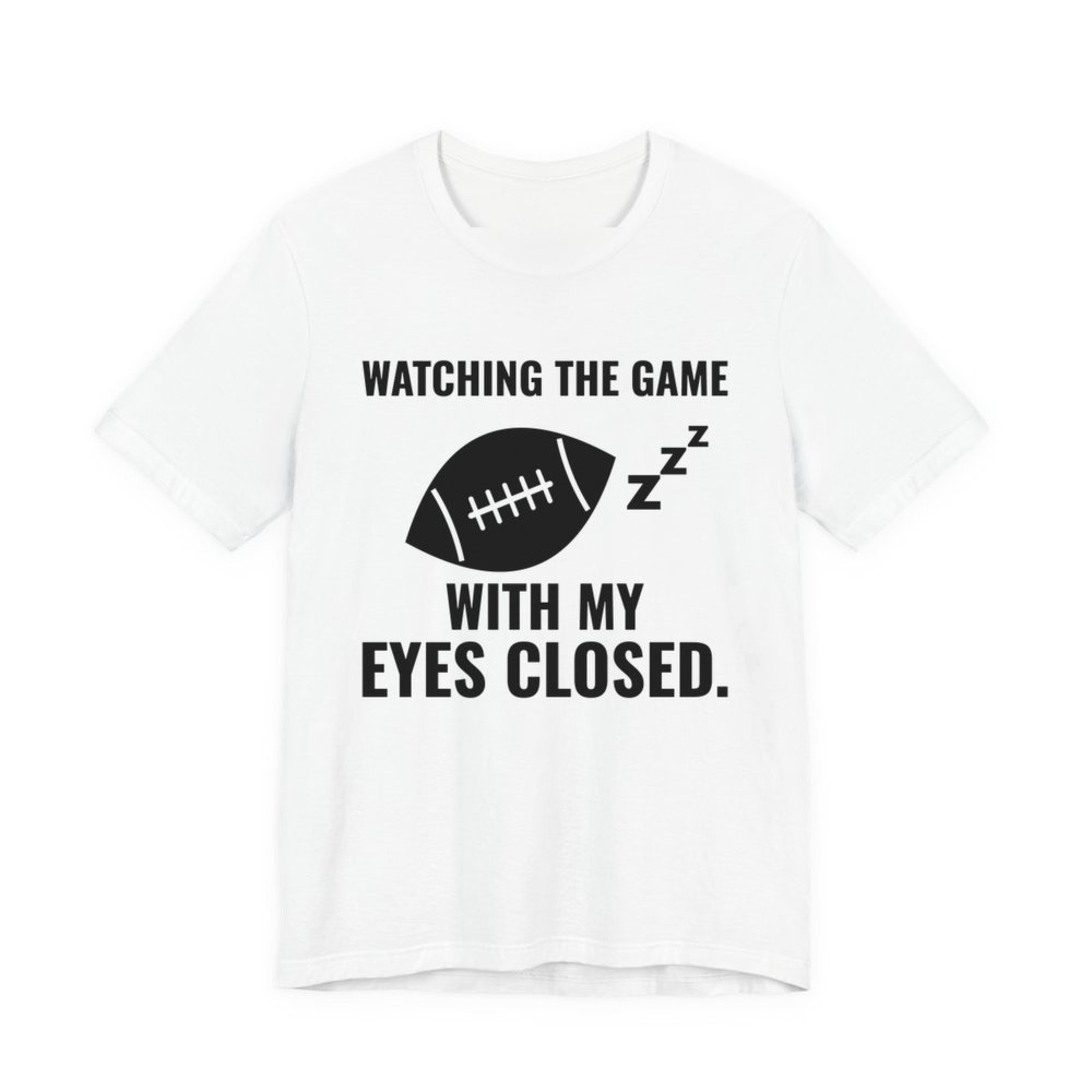 White t-shirt printed in dark ink with the words “Watching the Game With My Eyes Closed.”
